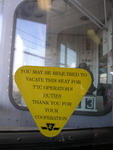 A sign inside a subway car